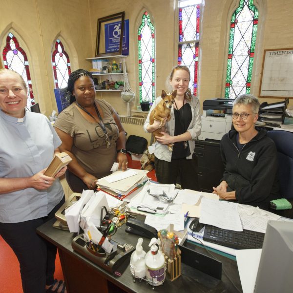 Left to right, The Reverend Dr. Alison Falby, Sachel, Sarah Ovens, holding Joshua, and Barb Todd in the office at All Saints Church Community Centre at 315 Dundas Street East at the corner of Dundas and Sherbourne streets in downtown Toronto on September 4, 2019. Photo/Michael Hudson